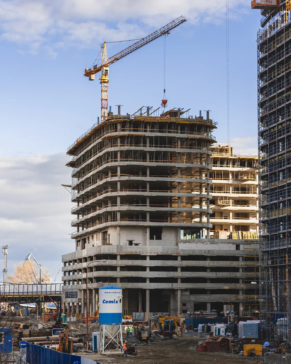 Multi-storey building under construction with a tower crane